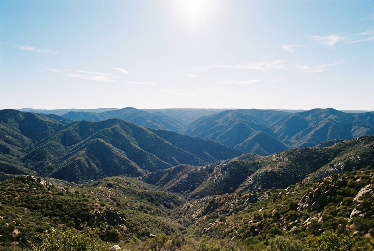 Noon: successive ridges of blue hills fading one behind another under a high hard sun, no shadow to speak of